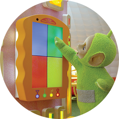 A light green character, with a round being face, is standing in front of a board with four colorful squares and pointing to it.